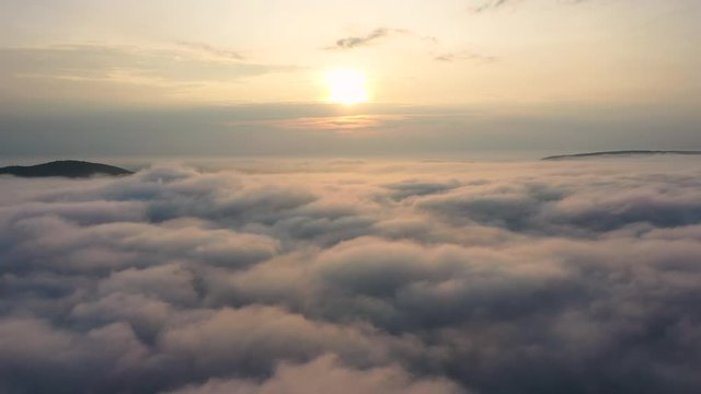 Aerial View of Sunrise. Flying in fog.Flight above clouds