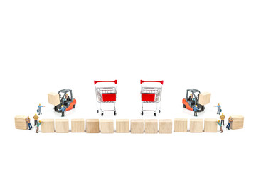 Miniature worker with wood block and shopping basket , shopping cart isolated on white background ,...