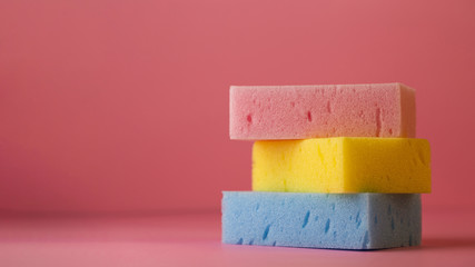 Top view of sponges on plain background with copy space