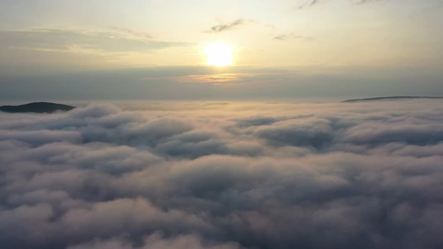 Aerial View of Sunrise. Flying in fog.Flight above clouds