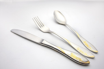 fork and spoon lay on white background