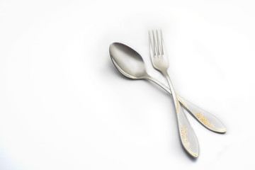 fork and spoon lay on white background