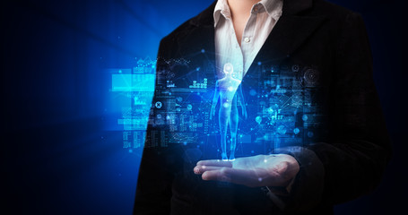 Young person holding hologram projection displaying health related graphs and symbols