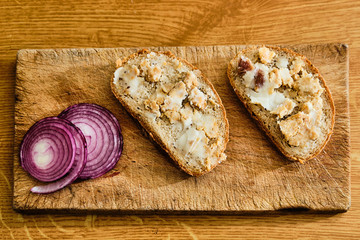 Bread with lard and greaves on cutting board - obrazy, fototapety, plakaty