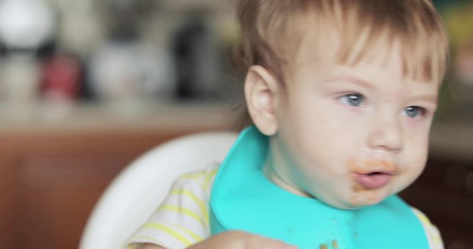 Infant boy eats meat