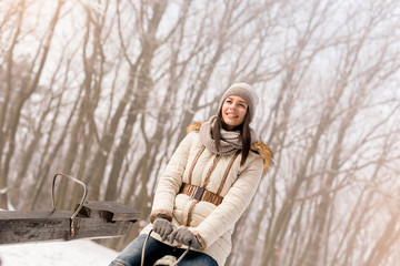 Girl on a seesaw on snowy winter day outdoors