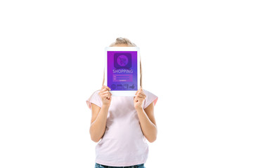 kid covering face while holding digital tablet with shopping app on screen isolated on white