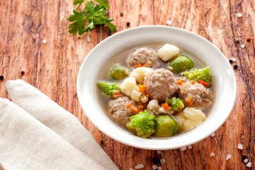 Hot thick soup with meatballs and cabbage mix.