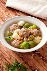 Hot thick soup with meatballs and cabbage mix.
