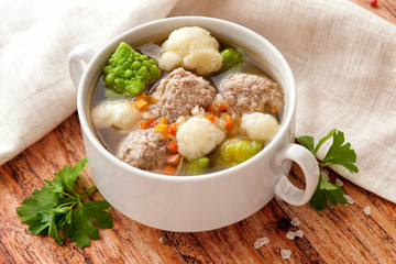 Hot thick soup with meatballs and cabbage mix.