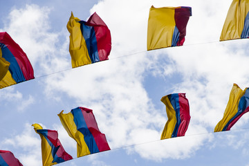 Colobian flags under blue sky