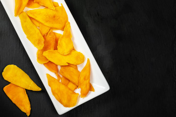 Dried Mango Fruit on Black Background. Selective focus.