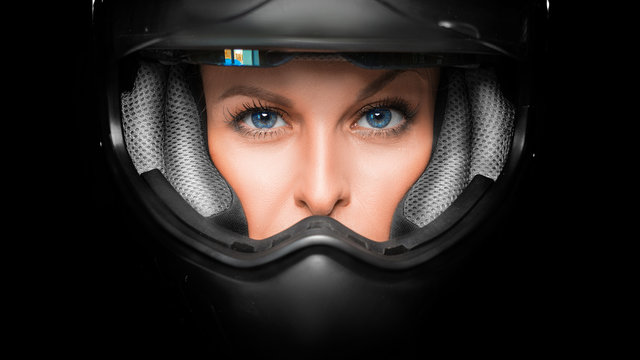 Close up view of a woman face in biker helmet.