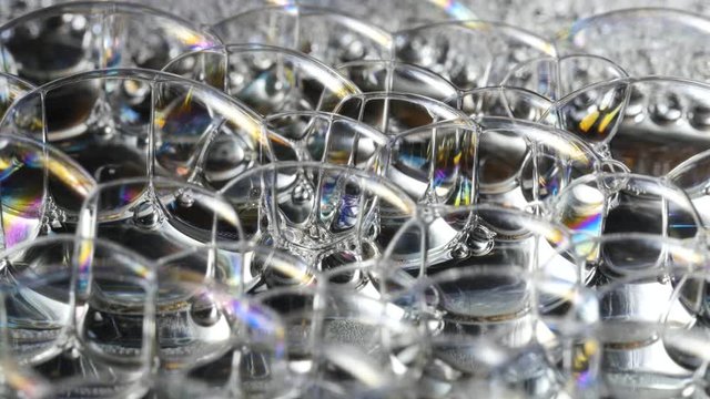Rainbow Soap Bubbles plopping and shining on isolated background