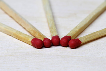 Symbol of danger with matches on white background top view