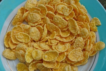 a plate full of yellow dried cornflakes