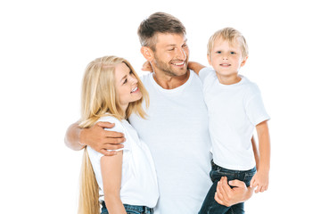 happy man hugging wife while holding in arms son isolated on white