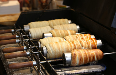 baking of Trdelnik a typical spit cake of Central Europe