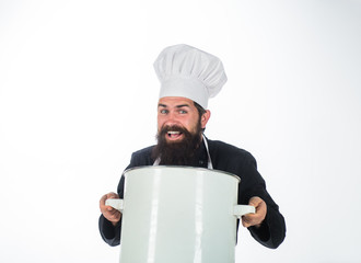 Male chef cooking with cooking pot. Chef in uniform holds pot. Cooking, food, profession concept. Casserole. Chef, cook or baker with saucepan in hand. Professional chef in uniform and hat holds pan.