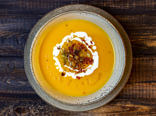 Pumpkin soup on a wooden background. Healthy eating.
