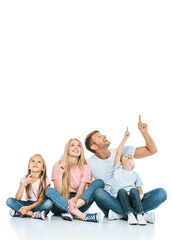 happy family pointing with fingers while looking up on white