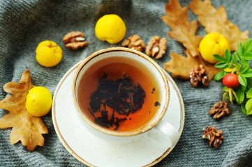 Cup of tea with autumn leaves