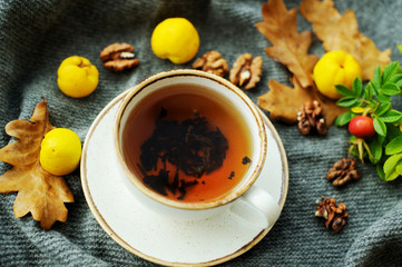 Cup of tea with autumn leaves