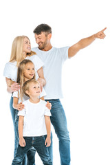 Fototapeta na wymiar happy man looking at wife while pointing with finger near kids on white
