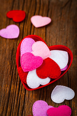 Valentines Day Background. Valentines Day Fabric Hearts Shaped on Wooden Background. Selective focus.