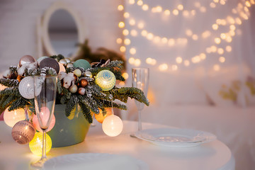 Glasses of champagne and New Year's decor on the festive table