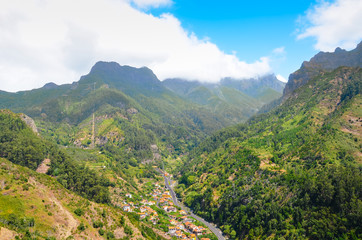 Fototapeta na wymiar Stunning view of picturesque village Serra de Aqua in Madeira Island, Portugal. Small city in a valley surrounded by green mountains. Portuguese landscape. Amazing travel destinations