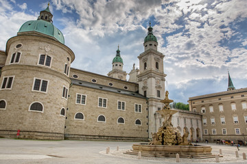 Fototapeta na wymiar The Residenzplatz is located in the center of the old town of Salzburg. View of the Salzburg Dom and Residenz Fountain on the Residenzplatz in Salzburg, Austria