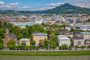 Naklejka premium Panoramic view of Salzach river and the garden in Schloßpark Mirabell in Salzburg with Barockmuseum and church St. Andrä, Austria