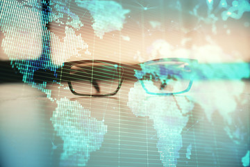 Business theme hologram with glasses on the table background. Concept of search. Double exposure.