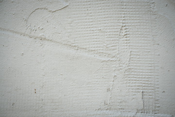 Light surface of concrete wall with grid imprints on it. light gray color. Horizontal orientation.