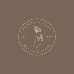 Beauty salon Logo hand holding a Ginkgo leaf In trendy linear minimalist style. Vector Round Emblem Beauty Studio