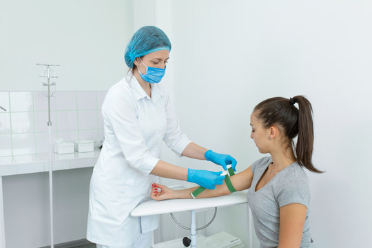 the nurse fastens the clip on the patients hand before the blood sampling procedure