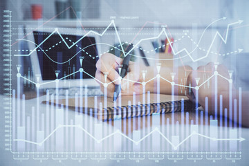 Financial graph displayed on woman's hand taking notes background. Concept of research. Double exposure