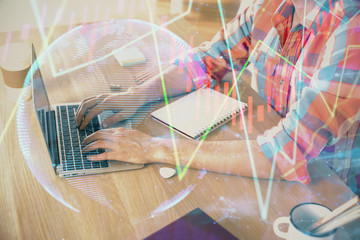 Multi exposure of forex graph with man working on computer on background. Concept of market...