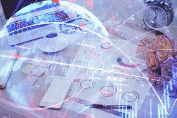 Financial chart drawing and table with computer on background. Multi exposure. Concept of international markets.