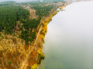 Beautiful view of the autumn forest and the lake from above.
