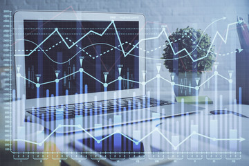 Forex market graph hologram and personal computer on background. Multi exposure. Concept of investment.