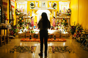 Candle among flowers day of the dead in a Mexican traditional offering in Dia de los Muertos Mexico