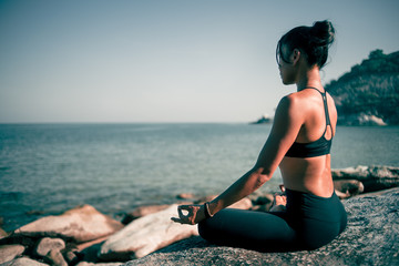 Asian woman yoga on the beach