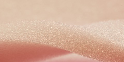 White pink artificial foam, soft texture on a light background.