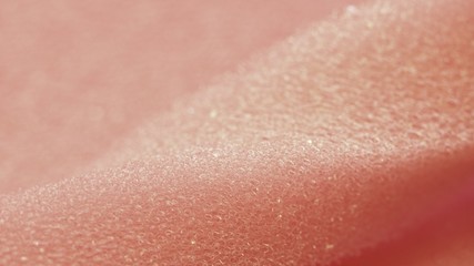 White pink artificial foam, soft texture on a light background.