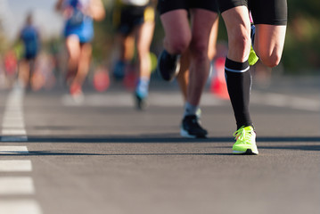 Marathon running race, people feet on city road