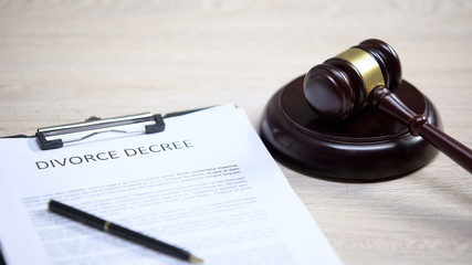 Divorce decree on table, gavel lying on sound block, court proceeding, rights