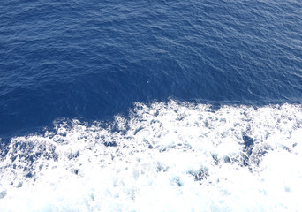white foam on the blue sea
