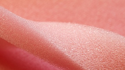White pink artificial foam, soft texture on a light background.